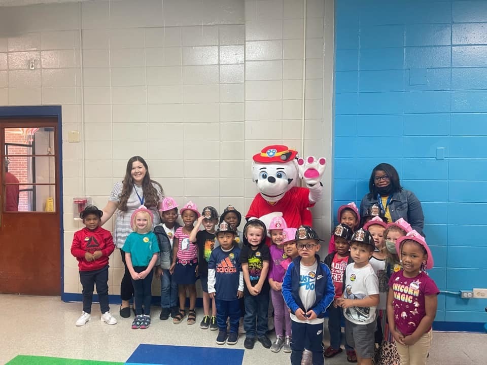 Students and teacher posing with Marshall from Paw Patrol