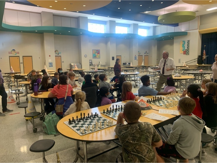 students sitting playing chess 