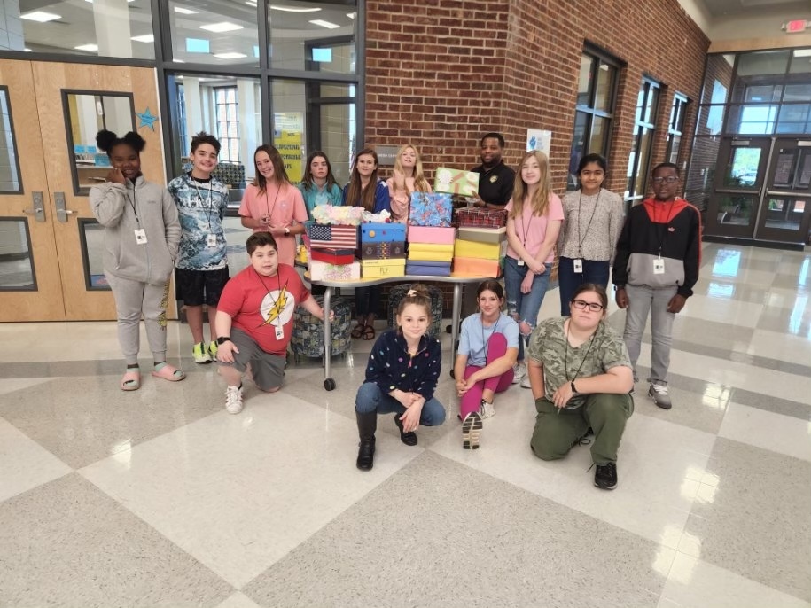  Beta students with United way boxes