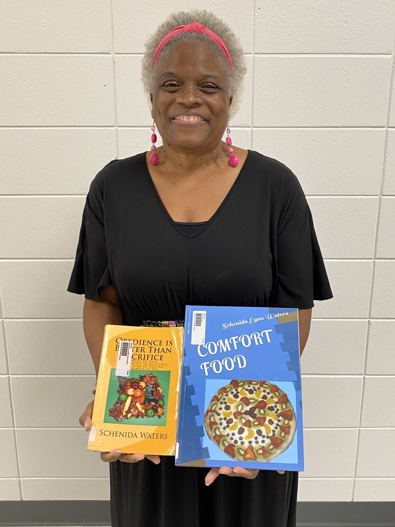 Mrs. Waters with the two books she donated to the CCMS library